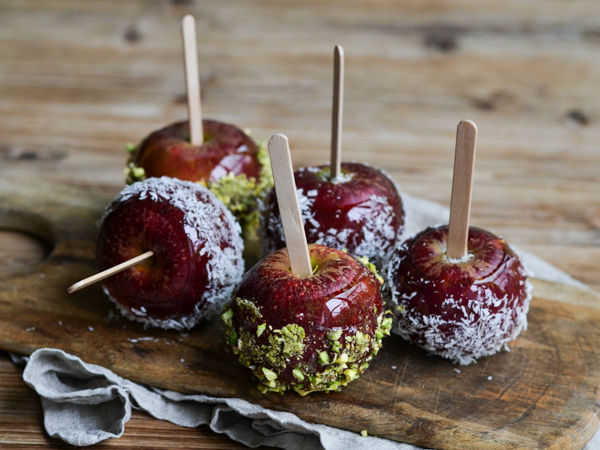 Fem æbler på pinde, dækket med kokos og pistacie
